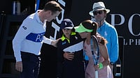 | Photo: AP/Asanka Brendon Ratnayake : Zeynep Sonmez of Turkey and umpire Chase Urban help a ball kid who fainted, from the court during her first round match against Ekaterina Alexandrova of Russia at the Australian Open tennis championship in Melbourne, Australia, Sunday, Jan. 18, 2026.