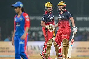 | Photo: PTI/Kunal Patil : Royal Challengers Bengaluru's Richa Ghosh, left, shakes hands with teammate Georgia Voll at the end of play during the Women's Premier League (WPL) T20 cricket match between Royal Challengers Bengaluru and Delhi Capitals, at DY Patil Stadium, in Navi Mumbai.