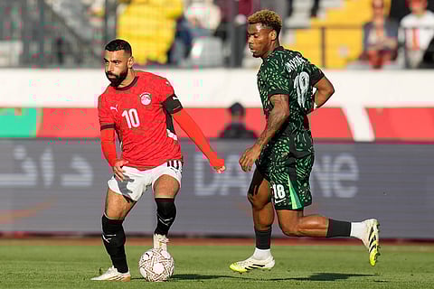 Egypt's Mohamed Salah is challenged by Nigeria's Raphael Onyedika during the Africa Cup of Nations third place game between Egypt and Nigeria in Casablanca, Morocco.