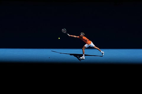 Gabriel Diallo of Canada plays a forehand return to Alexander Zverev of Germany during their first round match at the Australian Open tennis championship in Melbourne, Australia.