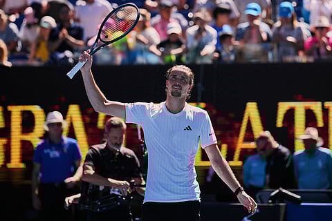 Alexander Zverev of Germany waves after defeating Gabriel Diallo of Canada in their first round match at the Australian Open tennis championship in Melbourne, Australia.