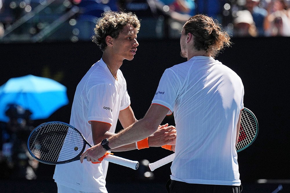 Alexander Zverev, right, of Germany is congratulated by Gabriel Diallo of Canada