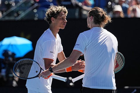 Alexander Zverev, right, of Germany is congratulated by Gabriel Diallo of Canada following their first round match at the Australian Open tennis championship in Melbourne, Australia.