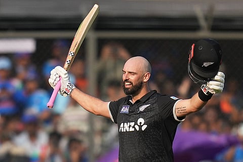 New Zealand's Daryl Mitchell celebrates his century during the third One Day International cricket match between India and New Zealand in Indore, India.