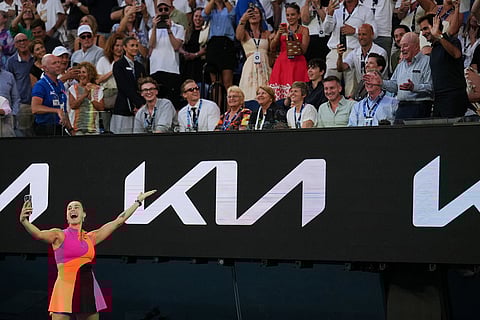 Aryna Sabalenka of Belarus takes a selfie with Rod Laver, second right, and Roger Federer, right, after defeating Tiantsoa Rakotomanga Rajaonah of France in their first round match at the Australian Open tennis championship in Melbourne, Australia.