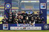 Photo: AP/Rafiq Maqbool : New Zealand's players pose with the trophy after winning the One Day International cricket series against India in Indore, India.