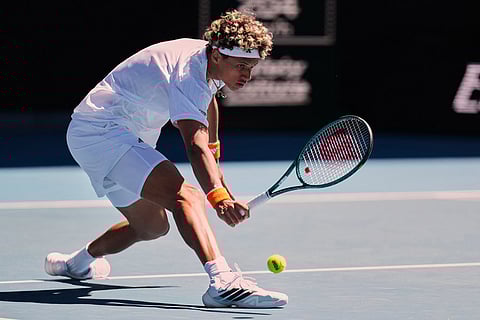 Gabriel Diallo of Canada plays a backhand return to Alexander Zverev of Germany during their first round match at the Australian Open tennis championship in Melbourne, Australia.