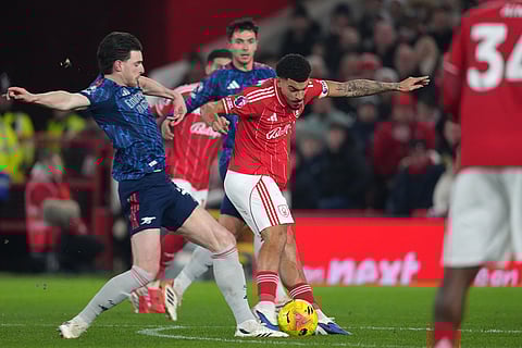 Nottingham Forest's Morgan Gibbs-White, center, attempts a shot at goal during the English Premier League soccer match between Nottingham Forest and Arsenal in Nottingham, England.