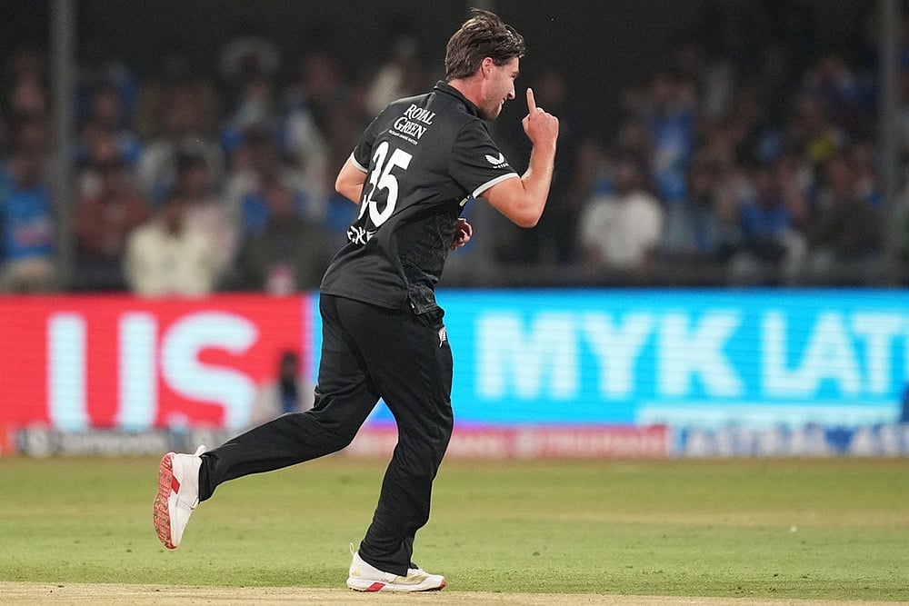 New Zealands Zak Foulkes celebrates the wicket of Indias Rohit Sharma