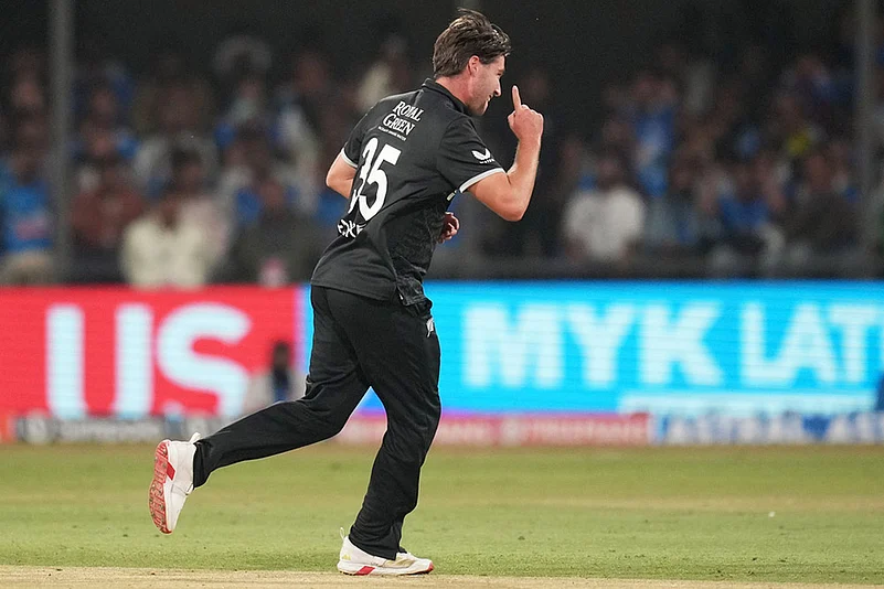 New Zealands Zak Foulkes celebrates the wicket of Indias Rohit Sharma