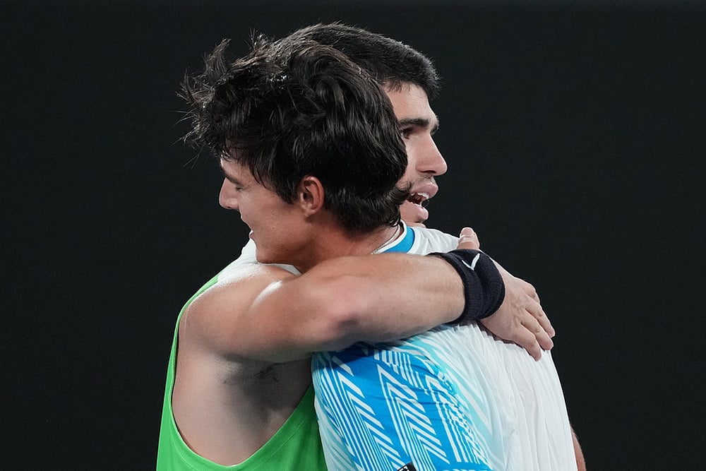 Carlos Alcaraz of Spain is congratulated by Adam Walton of Australia