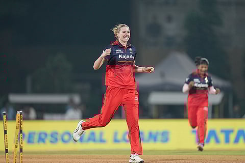 Royal Challengers Bengaluru's Lauren Bell celebrates after taking the wicket of Delhi Capitals' Laura Wolvaardt during the Women's Premier League (WPL) T20 cricket match between Royal Challengers Bengaluru and Delhi Capitals, at the DY Patil Stadium, in Navi Mumbai.