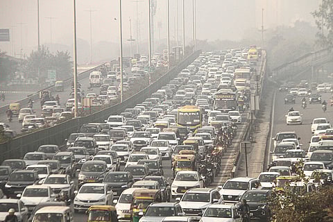 Vehicles stuck in a traffic jam on Delhi-Gurugram Expressway during a cold and foggy winter morning, in Gurugram. 