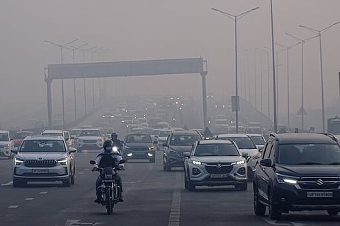 Commuters make their way during a cold and foggy winter morning, in New Delhi.