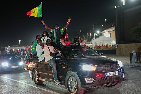 Fans celebrate after Senegal won the Africa Cup of Nations in Dakar, Senegal.