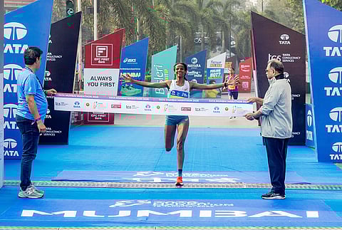 Ethiopia’s Yeshi Kalayu Chekole crossed the finish line in 02:25:13 seconds to win the overall women’s title at the Tata Mumbai Marathon 2026.  Also seen in the picture are Adille Sumariwala, Vice President of World Athletics, and Sridhar Venkataraman – Global Head – Delivery Centers & Shared Services, TCS.
