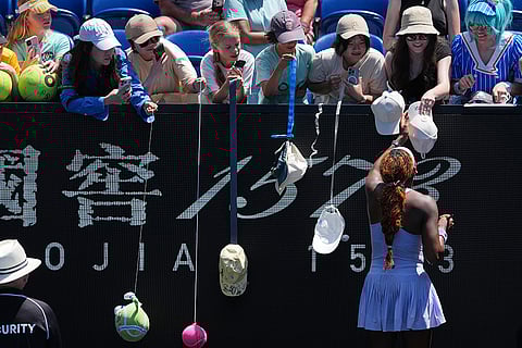 Coco Gauff of the U.S. signs autographs after defeating Kamilla Rakhimova of Uzbekistan following their first round match at the Australian Open tennis championship in Melbourne, Australia.