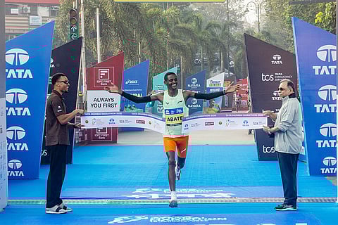 Ethiopia’s Tadu Abate Deme crossed the finish line in 2:09:55 seconds to win the overall men’s title at the Tata Mumbai Marathon 2026. In the picture also seen, Adille Sumariwala, Vice President, World Athletics and Andre De Grass, International Event Ambassador, TMM 2026.