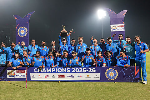 Vidarbha's players pose with the trophy after winning the Vijay Hazare Trophy 2025-26, at BCCI Centre of Excellence, in Bengaluru, Karnataka.