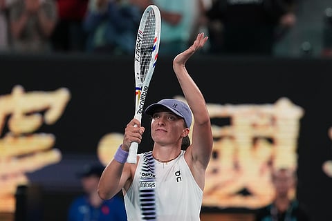Iga Swiatek of Poland reacts after defeating Yuan Yue of China in their first round match at the Australian Open tennis championship in Melbourne, Australia.