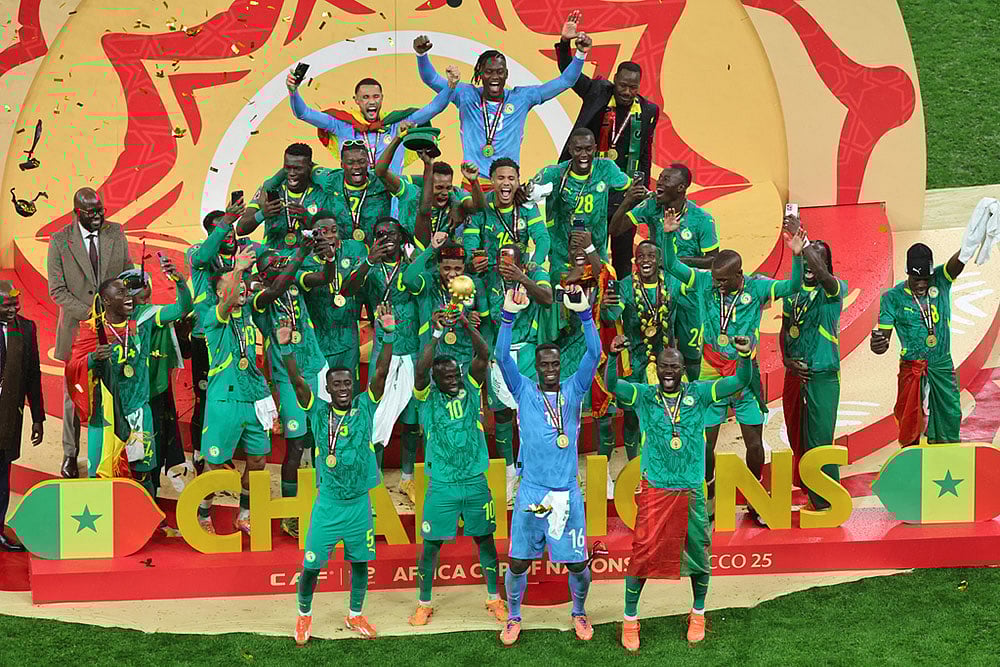 Senegal's Sadio Mane holds the trophy aloft as he celebrates with teammates after winning the Africa Cup of Nations final soccer match between Senegal and Morocco in Rabat, Morocco. - | Photo: AP/Youssef Loulidi