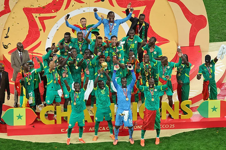 Senegal's Sadio Mane holds the trophy aloft as he celebrates with teammates after winning the Africa Cup of Nations final soccer match between Senegal and Morocco in Rabat, Morocco. - | Photo: AP/Youssef Loulidi