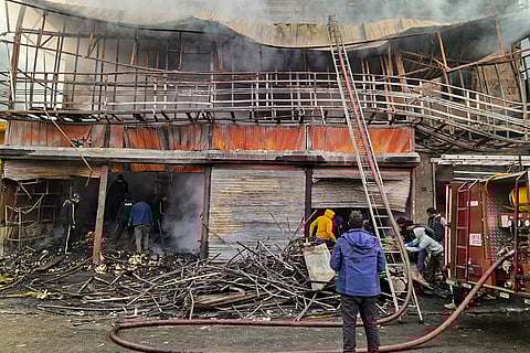 Cooling operation underway after a fire broke out at a shop, at Chandrapuri area of Rudraprayag district, Uttarakhand.