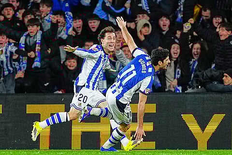Real Sociedad's Goncalo Guedes, right, celebrates with Real Sociedad's Alvaro Odriozola after scoring his side's second goal during the Spanish La Liga soccer match between Real Sociedad and Barcelona in San Sebastian, Spain.