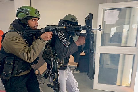 Security personnel during a joint mock drill at Qazigund railway station to assess preparedness ahead of Republic Day celebrations, in Anantnag, Jammu and Kashmir.