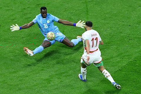 Senegal's goalkeeper Edouard Osoque Mendy saves from Morocco's Ismael Saibari during the Africa Cup of Nations final soccer match between Senegal and Morocco in Rabat, Morocco.