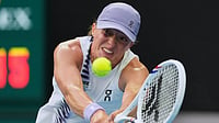 Photo: AP : Iga Swiatek of Poland plays a backhand return to Yuan Yue of China during their first round match at the Australian Open tennis championship in Melbourne.