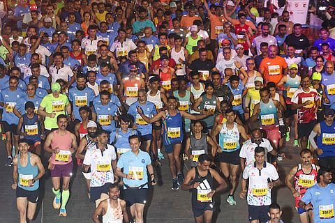 Jammu and Kashmir Chief Minister Omar Abdullah, left in green, takes part in the 21st edition of the Tata Mumbai Marathon, a World Athletics Gold Label Race, in Mumbai.