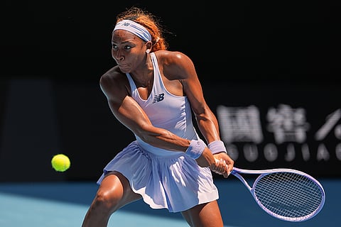 Coco Gauff of the U.S. plays a backhand return to Kamilla Rakhimova of Uzbekistan during their first round match at the Australian Open tennis championship in Melbourne, Australia.
