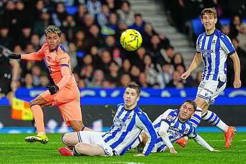 Barcelona's Lamine Yamal, left, in action during the Spanish La Liga soccer match between Real Sociedad and Barcelona in San Sebastian, Spain.