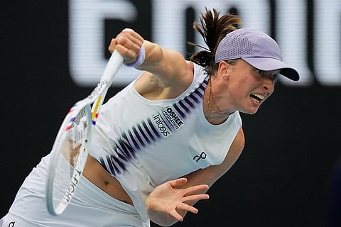 Iga Swiatek of Poland serves to Yuan Yue of China during their first round match at the Australian Open tennis championship in Melbourne, Australia.