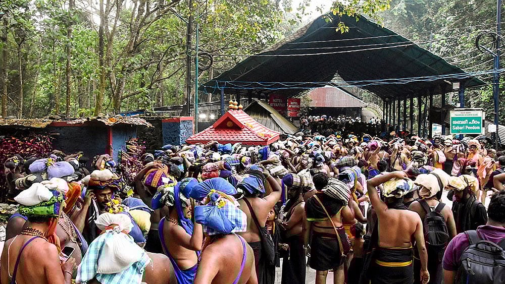 Devotees carry ‘Irumudi’ during the 'Vrischikam' after the Sabarimala temple opened for 'Mandala-Makaravilakku' pilgrimage season, in Pathanamthitta. - | Photo: PTI
