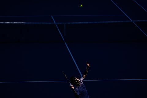 Gael Monfils of France serves to Dane Sweeny of Australia during their first round match at the Australian Open tennis championship in Melbourne, Australia.