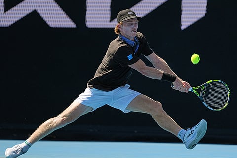 Dane Sweeny of Australia plays a backhand return to Gael Monfils of France during their first round match at the Australian Open tennis championship in Melbourne, Australia.