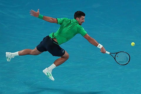 Novak Djokovic of Serbia plays a backhand return to Pedro Martinez of Spain during their first round match at the Australian Open tennis championship in Melbourne, Australia.