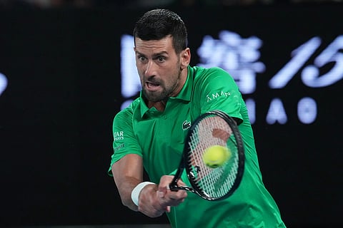 Novak Djokovic of Serbia plays a backhand return to Pedro Martinez of Spain during their first round match at the Australian Open tennis championship in Melbourne, Australia.