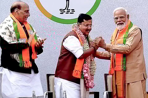 Prime Minister Narendra Modi felicitates newly elected BJP National President Nitin Nabin as the latter takes charge at party headquarters, in New Delhi. Defence Minister Rajnath Singh is also seen. 