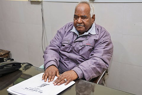 Braille Samachar Patra's editor-in-chief Chandraprakash Srivastava reads a newspaper, in Jaipur.