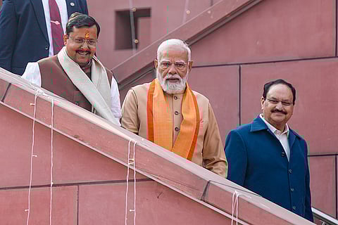 Prime Minister Narendra Modi with newly elected BJP National President Nitin Nabin and Union Minister and outgoing party president JP Nadda during Nabin's taking-charge ceremony, at party headquarters, in New Delhi. 