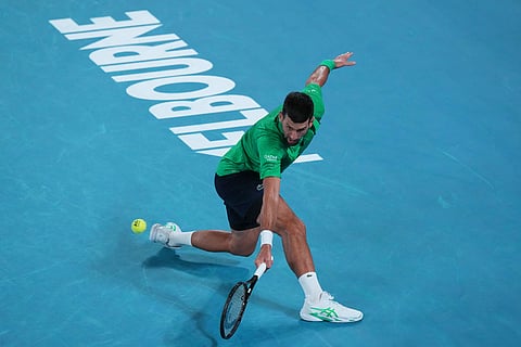Novak Djokovic of Serbia plays a backhand return to Pedro Martinez of Spain during their first round match at the Australian Open tennis championship in Melbourne, Australia.