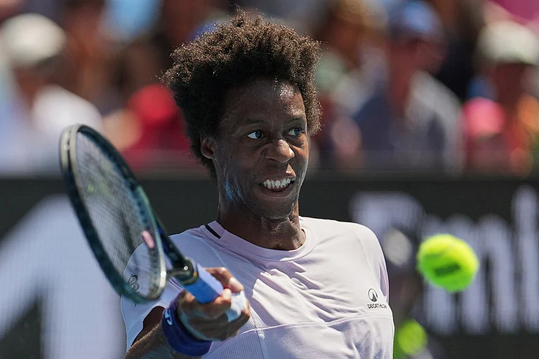 Gael Monfils of France plays a forehand return to Dane Sweeny of Australia during their first round match at the Australian Open tennis championship in Melbourne, Australia. - | Photo: AP/Dita Alangkara