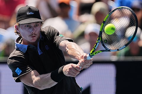 Dane Sweeny of Australia plays a backhand return to Gael Monfils of France during their first round match at the Australian Open tennis championship in Melbourne, Australia.