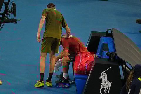 Jannik Sinner, left, of Italy consoles Hugo Gaston of France following Gaston's retirement from their first round match at the Australian Open tennis championship in Melbourne, Australia.