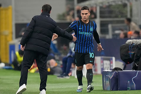 Inter Milan's Lautaro Martinez, right, leaves the field after substituting during the Champions League opening phase soccer match between Inter Milan and Arsenal in Milan, Italy.
