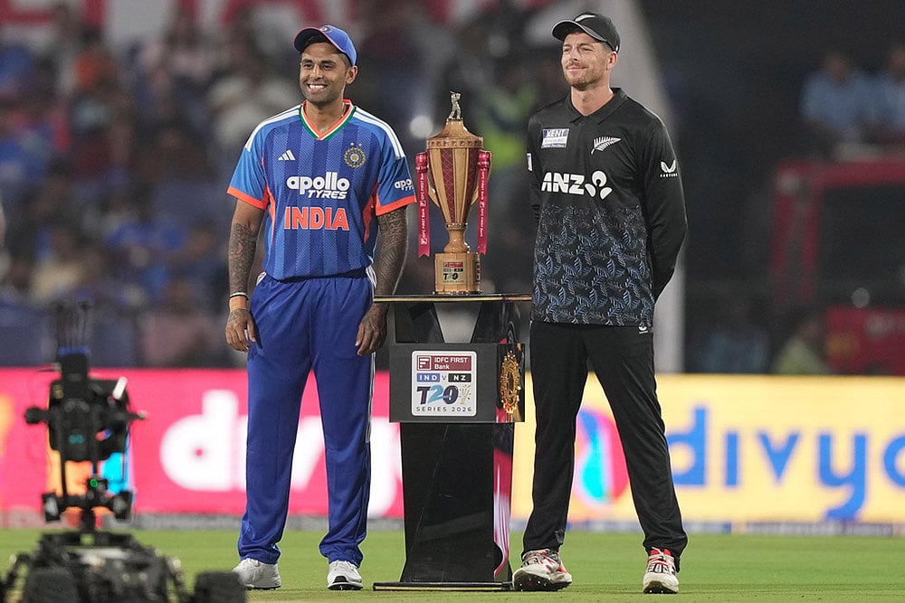 New Zealand's captain Mitchel Santner, right, and India's captain Suryakumar Yadav pose with the winners trophy ahead of the first T20 cricket match between India and New Zealand in Nagpur, India. - | Photo: AP/Mahesh Kumar A.