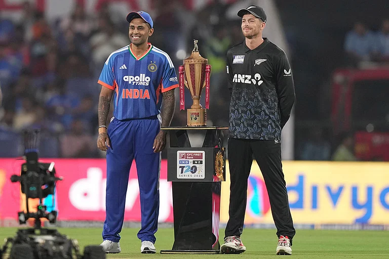 New Zealand's captain Mitchel Santner, right, and India's captain Suryakumar Yadav pose with the winners trophy ahead of the first T20 cricket match between India and New Zealand in Nagpur, India. - | Photo: AP/Mahesh Kumar A.